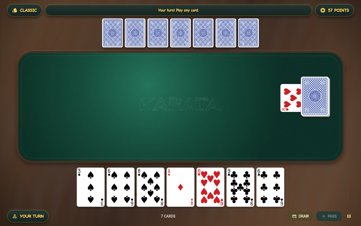 Karata with traditional playing cards on a green felt table